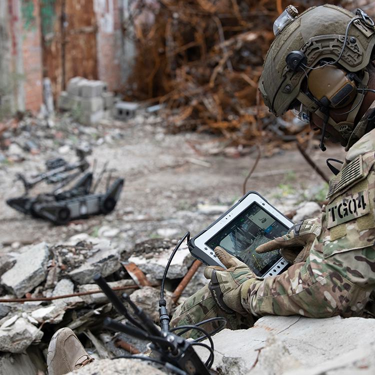 Military Man Controlling FLIR PackBot