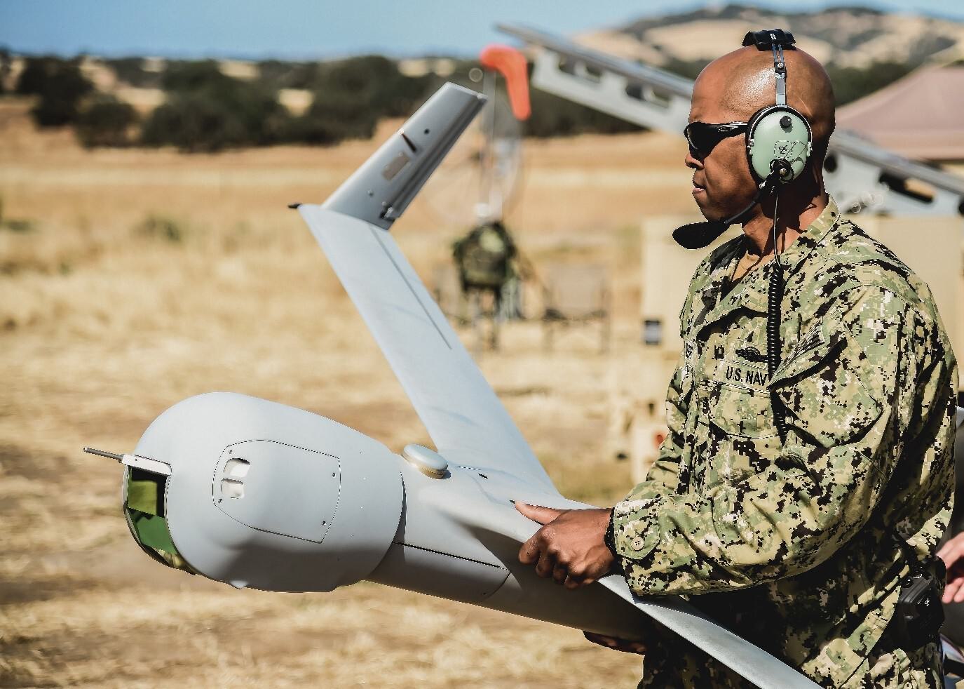 military member prepares to launch uas